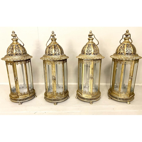 542 - STORM LANTERNS, 61cm high x 21cm diameter, a set of four, gilt metal frames and glazed sides. (4)