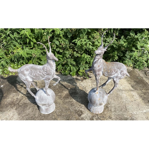 504 - SCULPTURAL STAG FIGURES, a pair, each mounted on a spherical base, cast metal, 100cm high x 60cm wid... 