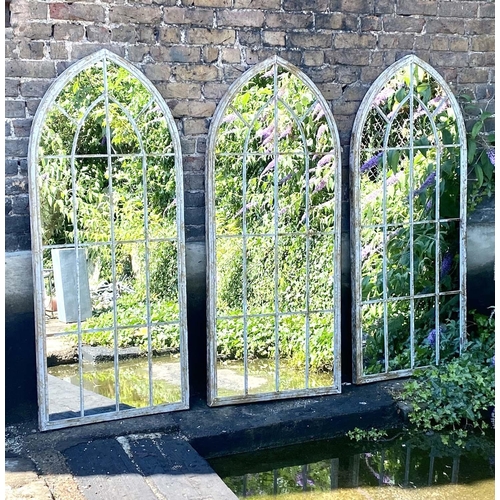 505 - ARCHITECTURAL GARDEN MIRRORS, a set of three, 160cm high x 67cm wide, Gothic style, aged metal frame... 