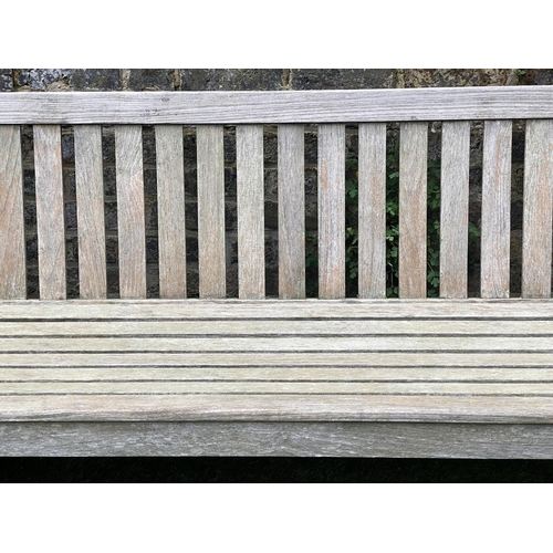 131 - GARDEN BENCH, weathered teak of large size and substantial slatted construction, 180cm W.