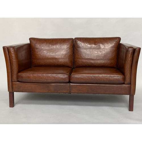 280 - 1970's Danish two seater grained tanned leather and teak supports. 147 cm W.