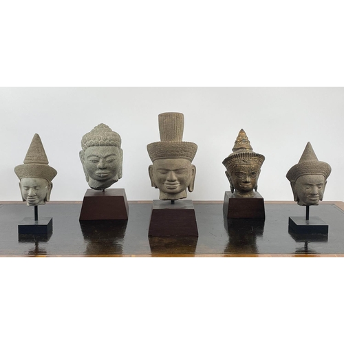 7 - A COLLECTION OF MOUNTED ASIAN STATUE HEADS, five various one in volcanic rock and one sandstone, tal... 