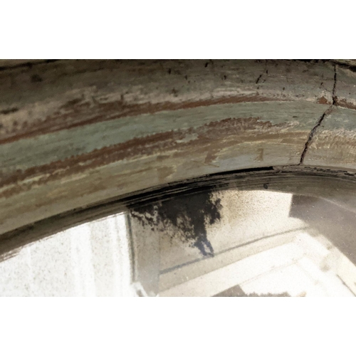 151 - CONVEX MIRROR, 122cm D by Paulo Moschino in a distressed finish.