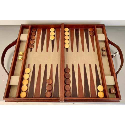 519 - BACKGAMMON SET, fitted in a leathered case, 7cm x 23cm x 40cm.