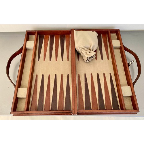 519 - BACKGAMMON SET, fitted in a leathered case, 7cm x 23cm x 40cm.