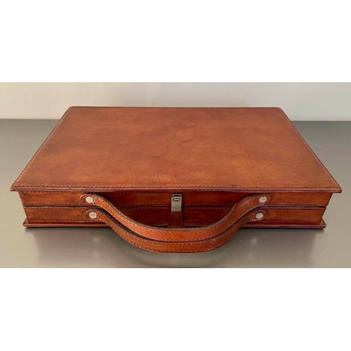 519 - BACKGAMMON SET, fitted in a leathered case, 7cm x 23cm x 40cm.