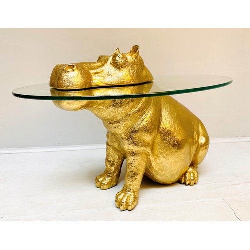 565 - HIPPOPOTAMUS FIGURAL TABLE, 65cm high x 50cm wide x 45cm deep, glass circular top, gilt finish.