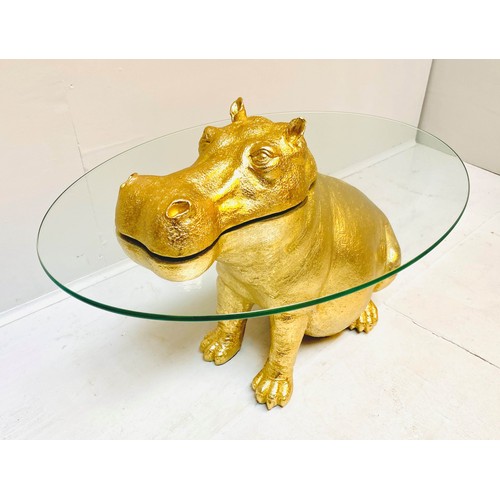 565 - HIPPOPOTAMUS FIGURAL TABLE, 65cm high x 50cm wide x 45cm deep, glass circular top, gilt finish.