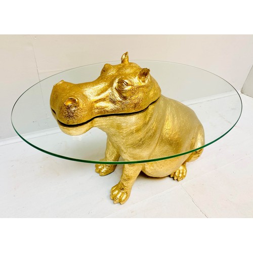 565 - HIPPOPOTAMUS FIGURAL TABLE, 65cm high x 50cm wide x 45cm deep, glass circular top, gilt finish.