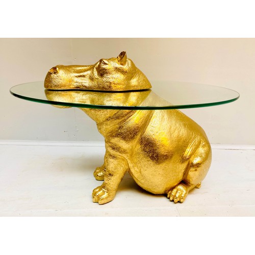 565 - HIPPOPOTAMUS FIGURAL TABLE, 65cm high x 50cm wide x 45cm deep, glass circular top, gilt finish.