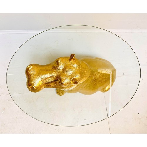 565 - HIPPOPOTAMUS FIGURAL TABLE, 65cm high x 50cm wide x 45cm deep, glass circular top, gilt finish.