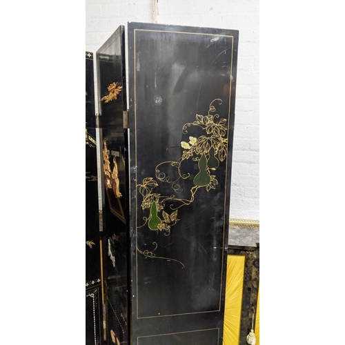 150 - CHINESE FOUR FOLD BLACK LACQUER SCREEN, with raised bone inlay depicting figural garden scenes and v... 