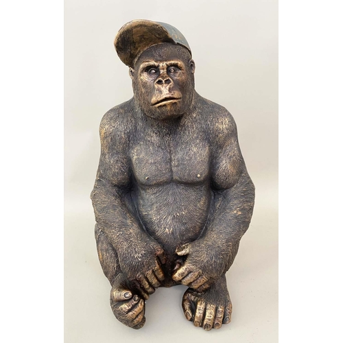 416 - GORILLA WEARING A BASEBALL CAP, 60cm H x 40cm W x 34cm D, faux bronze.