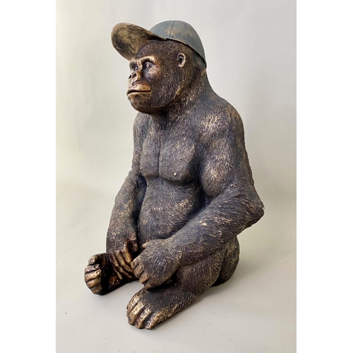 416 - GORILLA WEARING A BASEBALL CAP, 60cm H x 40cm W x 34cm D, faux bronze.