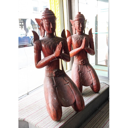 435 - THIA THEPPANOM COUPLE, carved wood, red lacquered finish, 128cm H. (2)