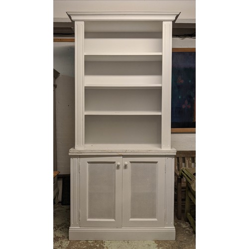 437 - BOOKCASE, 245cm H x 41cm x 107cm, painted finish with grilled doors.