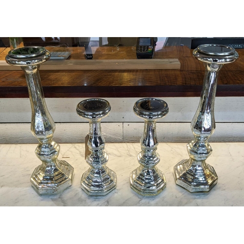 441 - CANDLESTICKS, two graduated pairs, 46cm H at tallest, eglomise style glazed finish ceramic. (4)