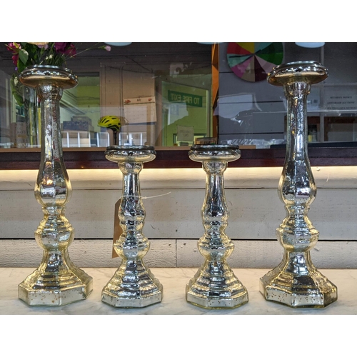 441 - CANDLESTICKS, two graduated pairs, 46cm H at tallest, eglomise style glazed finish ceramic. (4)