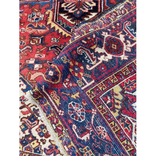 69 - ANTIQUE PERSIAN HERIZ CARPET, 310cm x 245cm.