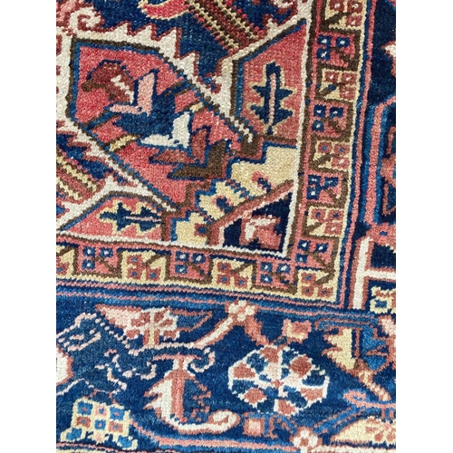 69 - ANTIQUE PERSIAN HERIZ CARPET, 310cm x 245cm.