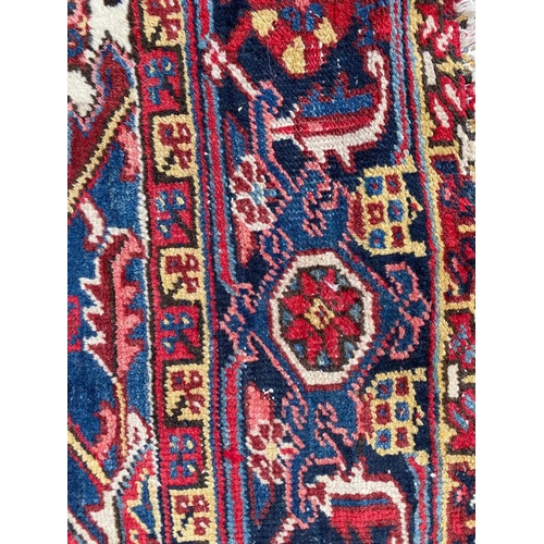 69 - ANTIQUE PERSIAN HERIZ CARPET, 310cm x 245cm.