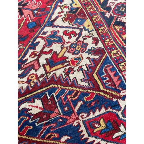 69 - ANTIQUE PERSIAN HERIZ CARPET, 310cm x 245cm.