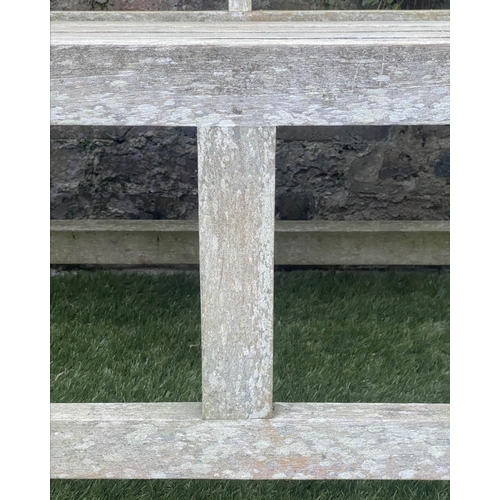 128 - LUTYENS STYLE GARDEN BENCH, weathered teak of slatted construction, 165cm W.