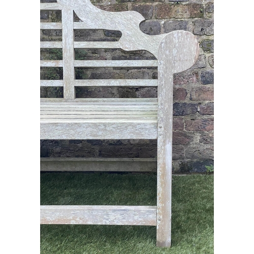 128 - LUTYENS STYLE GARDEN BENCH, weathered teak of slatted construction, 165cm W.