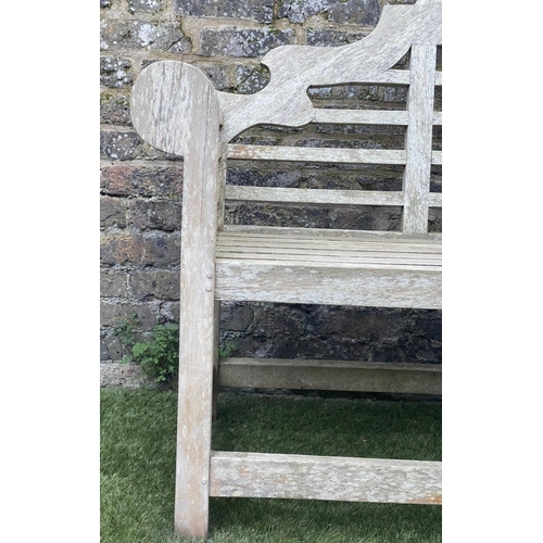 128 - LUTYENS STYLE GARDEN BENCH, weathered teak of slatted construction, 165cm W.