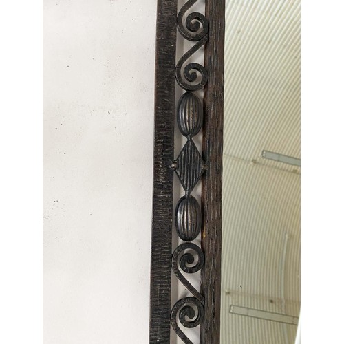 463 - ART DECO WALL MIRROR, French bevelled tapering mirror within a wrought iron foliate and Vitruvian sc... 