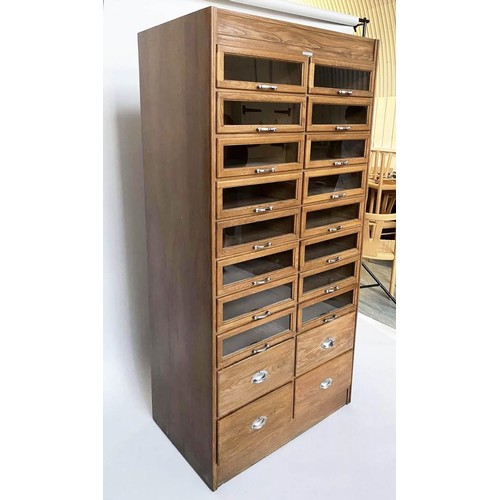 203 - HABERDASHERY CABINET, mid 20th century oak with sixteen glass fronted drawers above four short deep ... 