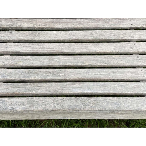 126 - GARDEN BENCH, silvery weathered teak of slatted and pegged construction, 180cm W.