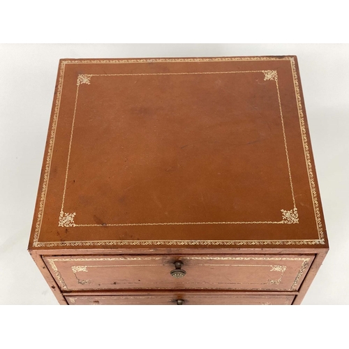 130 - FILING CHESTS, a pair, 1970's gilt tooled tan leather clad each with two fall front pullout drawers ... 