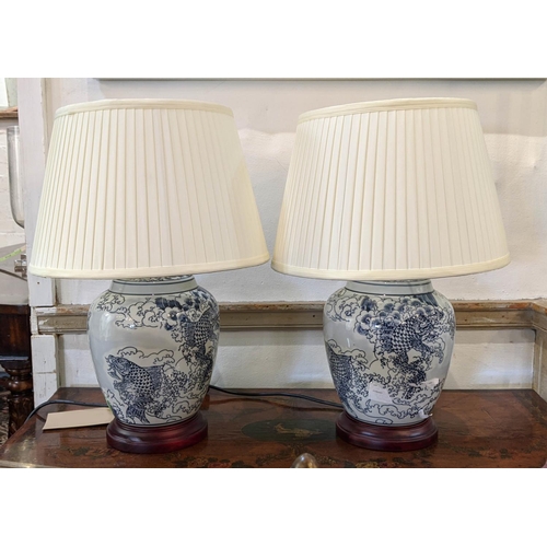 390 - TABLE LAMPS, a pair, Chinese export style blue and white ceramic, each 51cm tall with shades. (2)