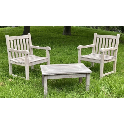 128 - GARDEN ARMCHAIRS AND TABLE, a pair, weathered teak of slatted and pegged construction, 61cm W togeth... 