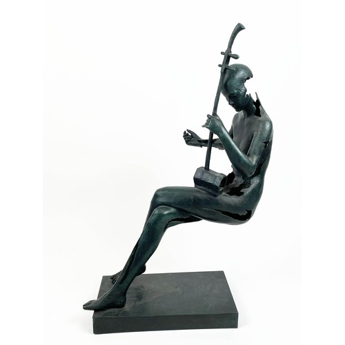 26 - ABSTRACT MUSICIAN SCULPTURE, in floating seated position  in verdigris finish, 87cm H.