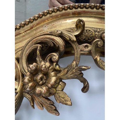 215 - OVERMANTEL MIRROR, 19th century French giltwood and gesso moulded with foliate arched and C scroll t... 