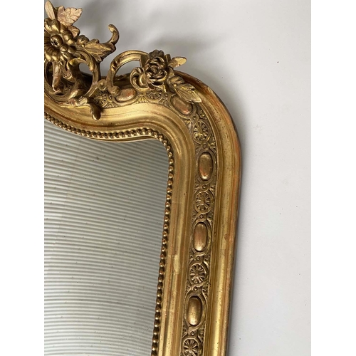 215 - OVERMANTEL MIRROR, 19th century French giltwood and gesso moulded with foliate arched and C scroll t... 