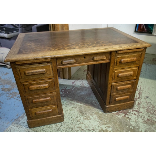 122 - DESK, 77cm H x 122cm W x 80cm D, circa 1925 oak with two slides and eight drawers.