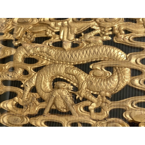 93 - LOW TABLE, Chinese lacquered and gilt, rectangular with carved dragon giltwood panel and glass, 64cm... 