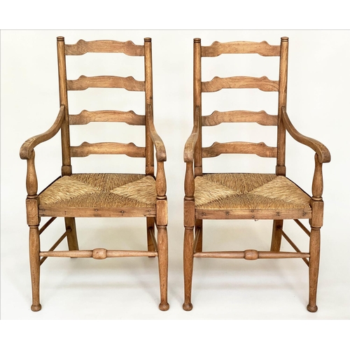 104 - ARMCHAIRS, a pair, early 20th century English oak with ladder backs and rush seats, 55cm W. (2)