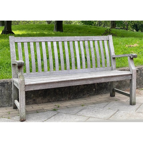 113 - GARDEN BENCH, silvery weathered teak of slatted and pegged construction, 152cm W.