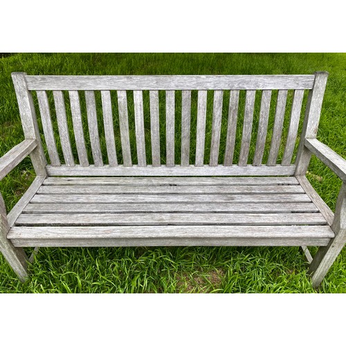 239 - GARDEN BENCH, weathered teak of slatted construction with shaped back and scroll arms, 152cm W.