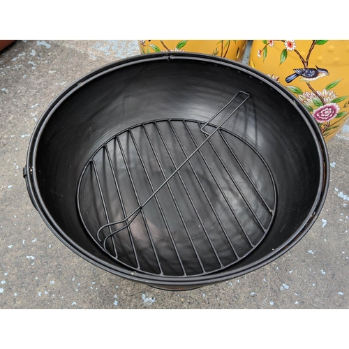 393 - FIRE BOWL, with lift off guard and grill, black painted metal, 60cm diam x 55cm.