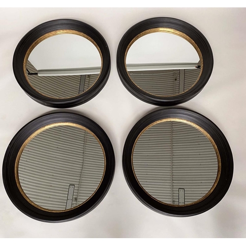 347 - CIRCULAR WALL MIRRORS, a set of four, Regency style, ebonised with gilt detail, each 95cm W. (4)