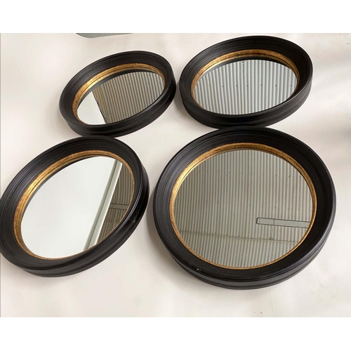 347 - CIRCULAR WALL MIRRORS, a set of four, Regency style, ebonised with gilt detail, each 95cm W. (4)