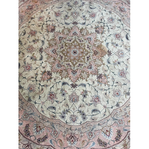 128 - TABRIZ PART SILK RUG, 216cm x 152cm, together qwith a matching circular rug, 155cm diam. (2)