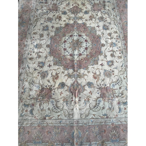 128 - TABRIZ PART SILK RUG, 216cm x 152cm, together qwith a matching circular rug, 155cm diam. (2)