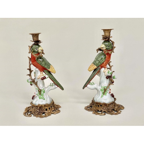 160 - PARROT CANDLESTICKS, a pair, Continental style decorated porcelain and gilt metal mounted, 36cm H. (... 