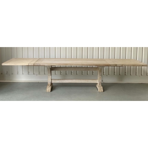 FARMHOUSE HARVEST TABLE, substantial limed oak with thick planked and cleated top raised upon twin 'Y' trestles and stretcher, extending with two additional leaves, 200cm W x 1000cm 76cm H, extending to 350cm W.